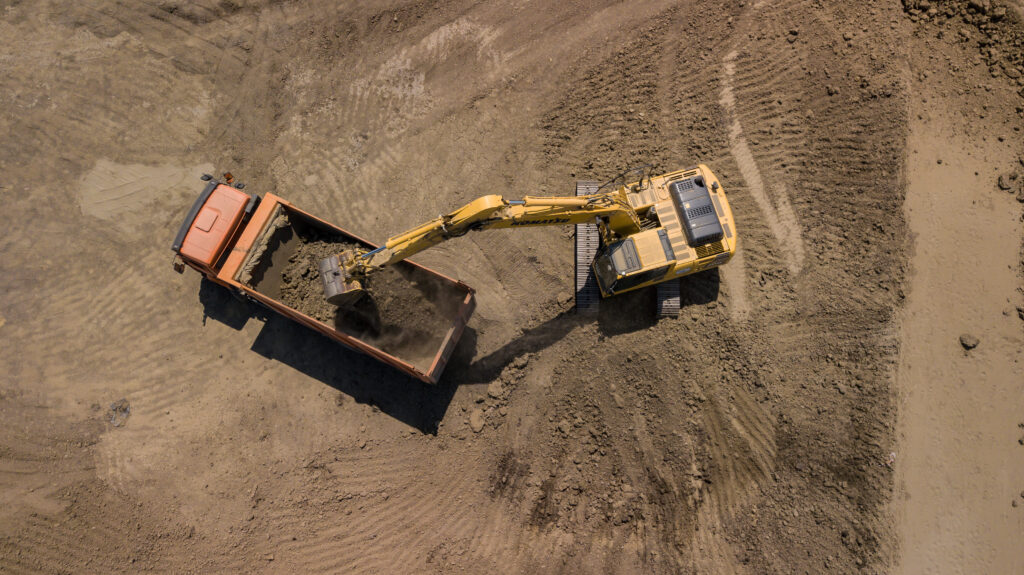 Aerial,Photo,Of,Excavator,Pours,Sand,Into,The,Truck.,On